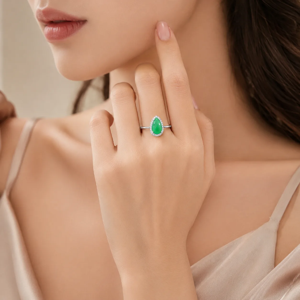Emerald Ring with a Teardrop-Shaped Halo